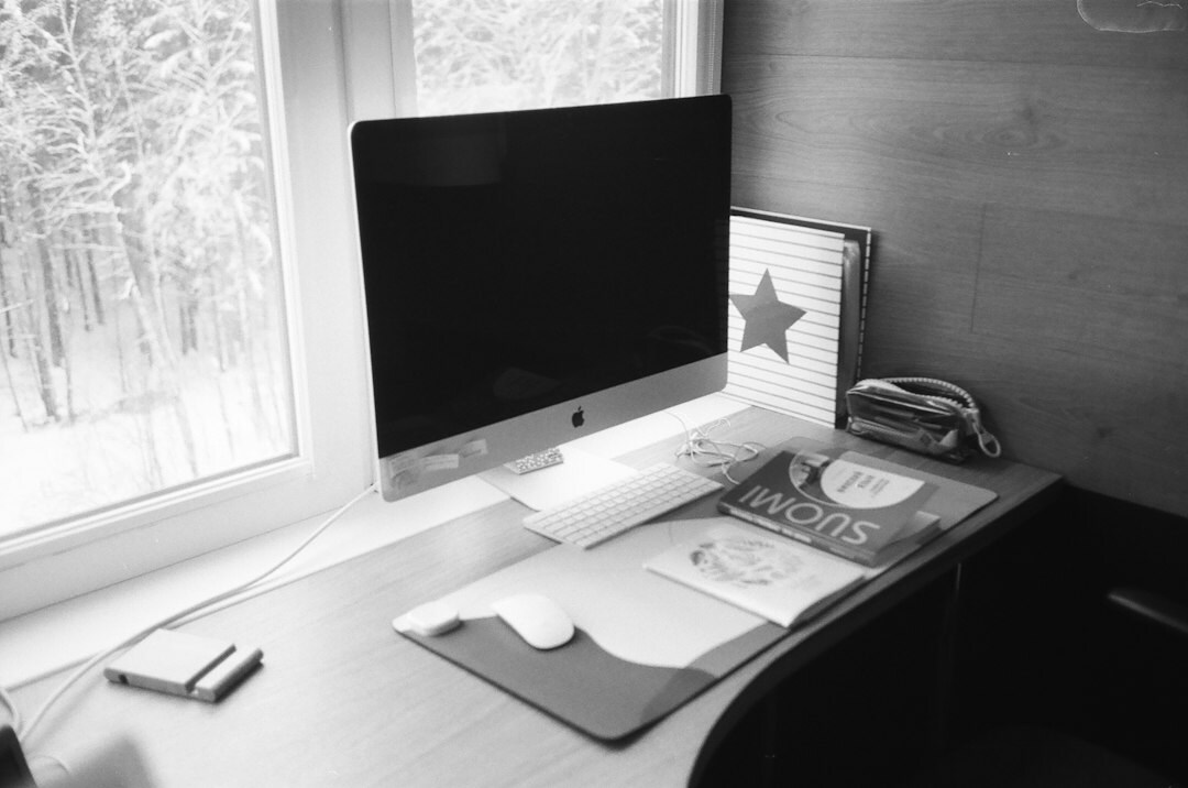 Quiet study room with a wooden desk, lamp and notebook